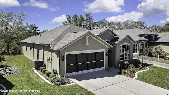 view of front facade featuring central air condition unit, stucco siding, driveway, a front lawn, and an attached garage