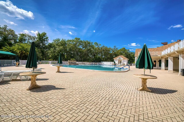 pool featuring a patio area and fence