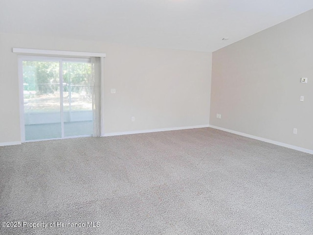 carpeted spare room with baseboards