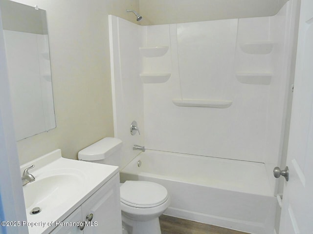 full bathroom featuring vanity, toilet, wood finished floors, and bathtub / shower combination