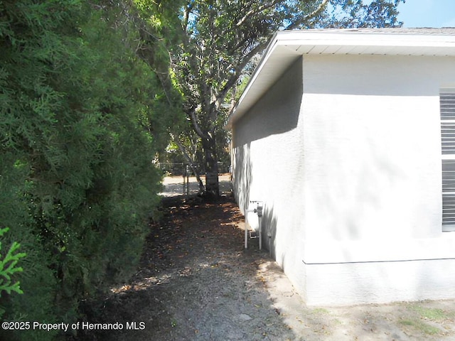 view of side of property featuring stucco siding