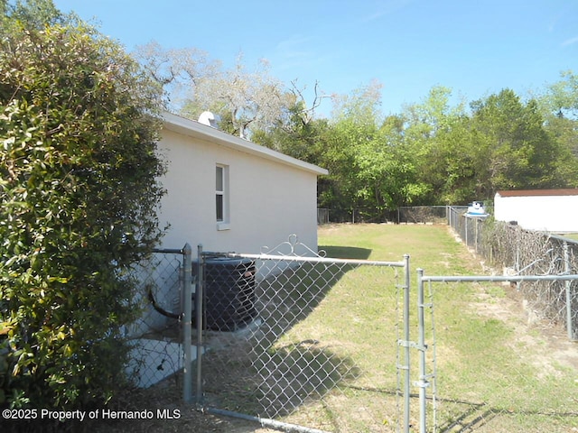 view of yard featuring fence and a gate