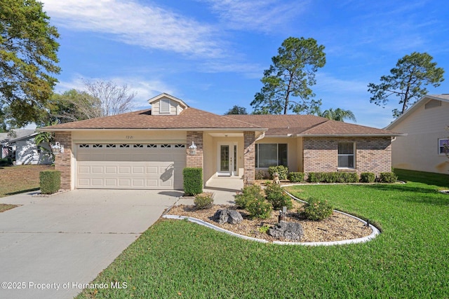 single story home featuring brick siding, an attached garage, concrete driveway, and a front lawn