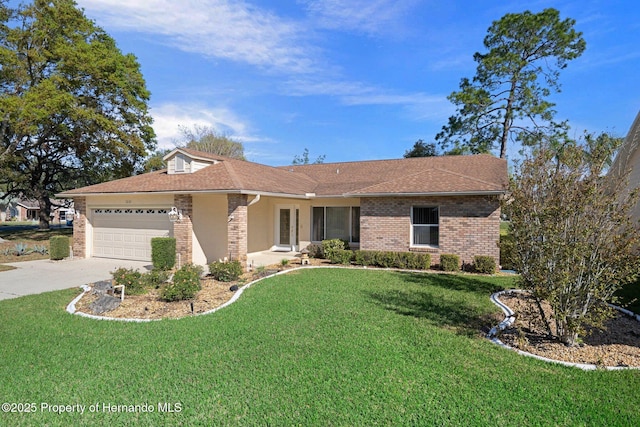 ranch-style house featuring a front lawn, an attached garage, brick siding, and concrete driveway