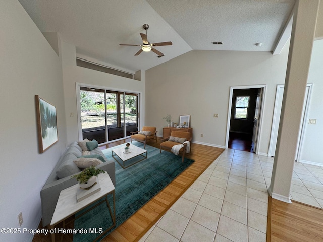 living room featuring light wood-style floors, visible vents, and a wealth of natural light