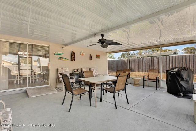 view of patio with outdoor dining space, grilling area, fence, and ceiling fan