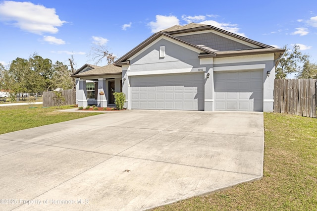 view of front of property with fence, concrete driveway, a front yard, stucco siding, and an attached garage