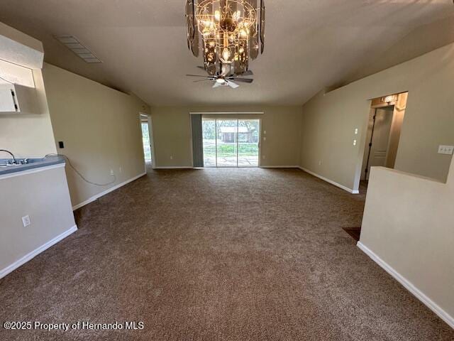 interior space featuring visible vents, baseboards, an inviting chandelier, and vaulted ceiling