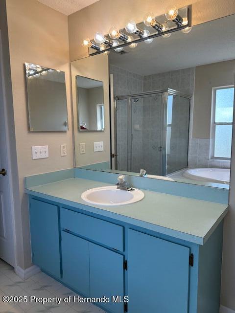 full bath with vanity and a stall shower