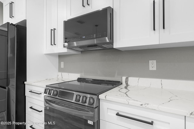 kitchen featuring light stone counters, stainless steel appliances, and white cabinetry