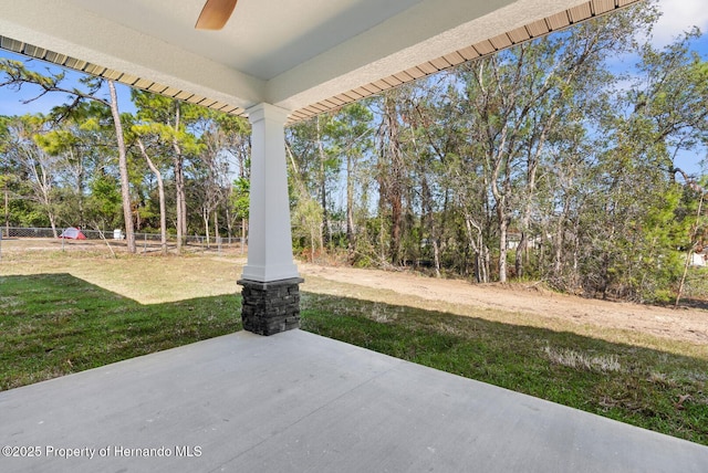 view of patio featuring a ceiling fan and fence