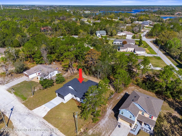 birds eye view of property with a residential view and a wooded view