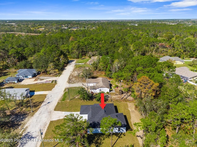 birds eye view of property with a wooded view