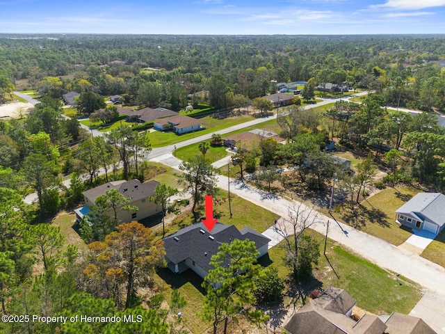 drone / aerial view featuring a view of trees