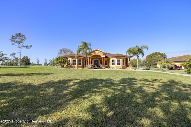 mediterranean / spanish-style house with a front yard