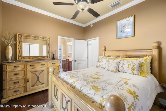 bedroom featuring a ceiling fan, visible vents, dark wood-type flooring, ensuite bathroom, and crown molding