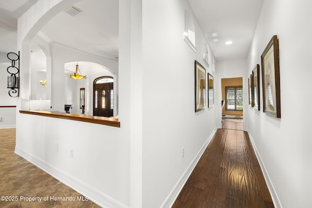 corridor with visible vents, recessed lighting, baseboards, and wood finished floors