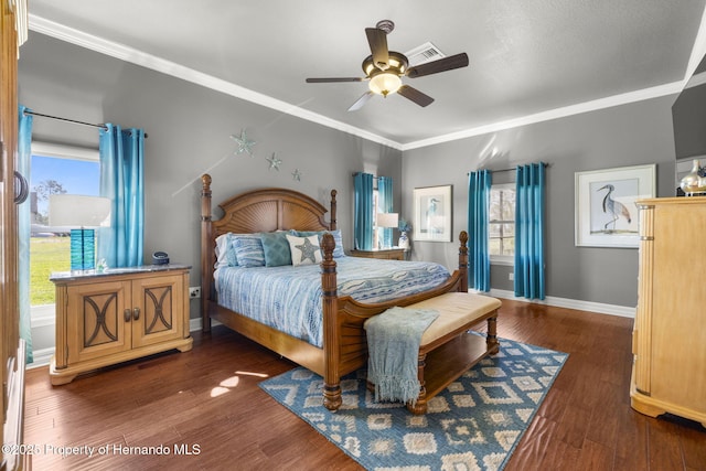 bedroom featuring visible vents, ceiling fan, baseboards, ornamental molding, and wood finished floors