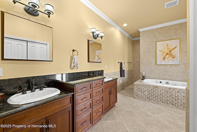 bathroom featuring tile patterned flooring, visible vents, crown molding, double vanity, and a sink
