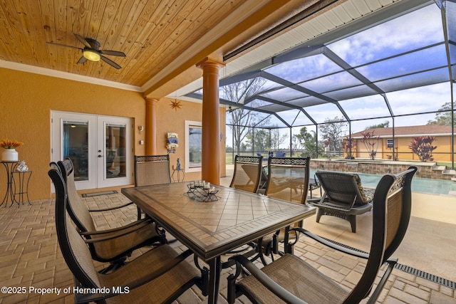 view of patio / terrace featuring outdoor dining space, glass enclosure, an outdoor pool, ceiling fan, and french doors