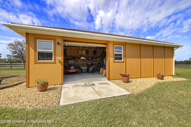 view of outbuilding featuring an outbuilding and fence