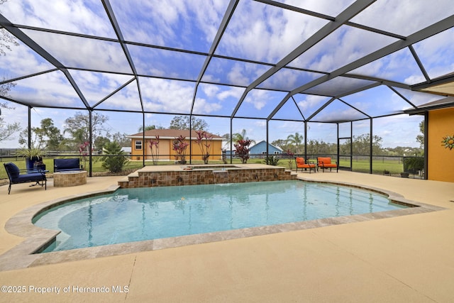 pool featuring an in ground hot tub, a patio area, and a lanai