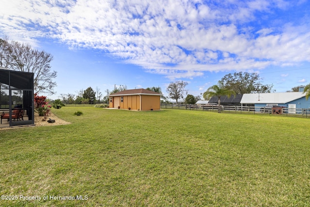 view of yard with an outdoor structure and fence