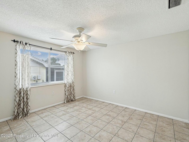 unfurnished room featuring visible vents, a textured ceiling, baseboards, and a ceiling fan