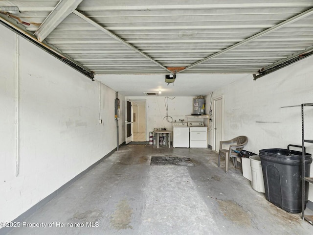 garage with water heater, washer and dryer, and a garage door opener