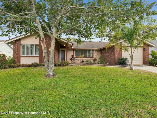 ranch-style home featuring an attached garage, driveway, and a front lawn