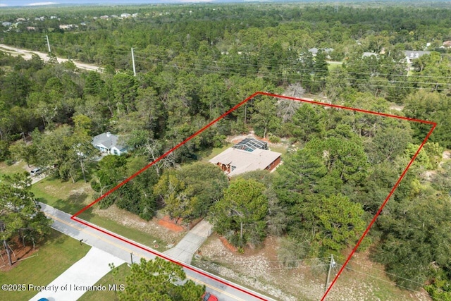 drone / aerial view featuring a forest view