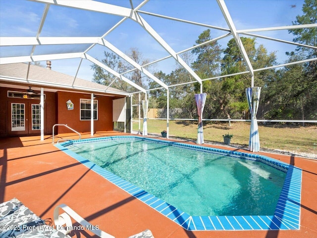 outdoor pool with ceiling fan, french doors, a lanai, and a patio area