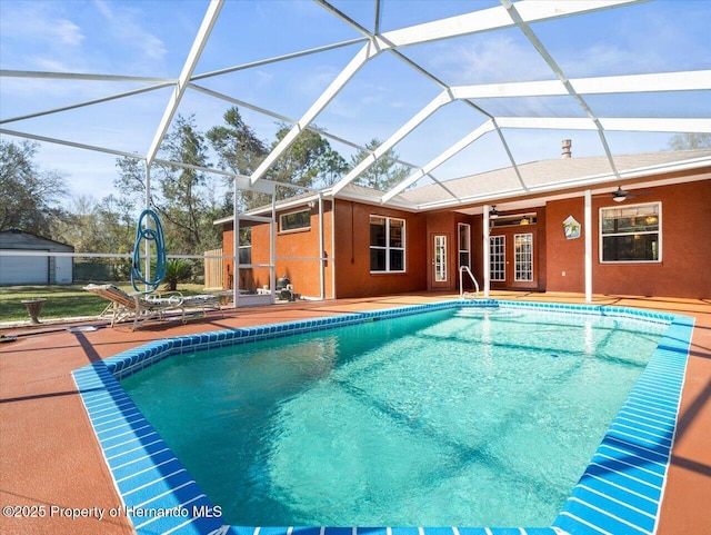 pool featuring a patio area, french doors, a lanai, and a ceiling fan