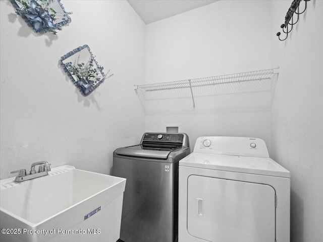 laundry room with a sink, independent washer and dryer, and laundry area