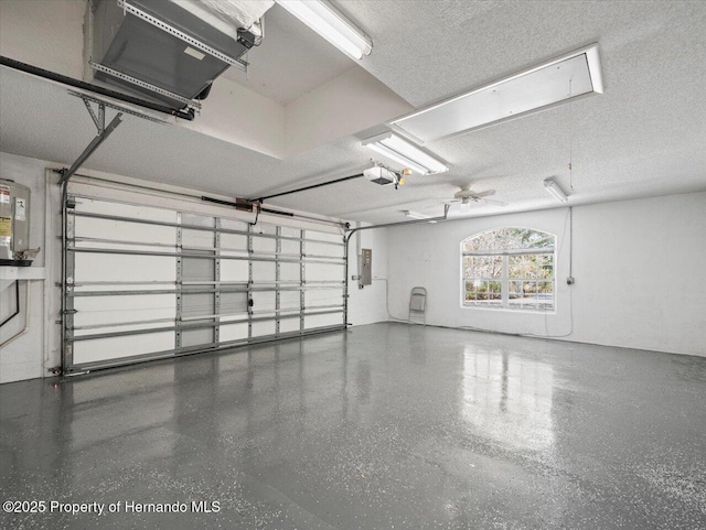 garage featuring electric panel and a garage door opener