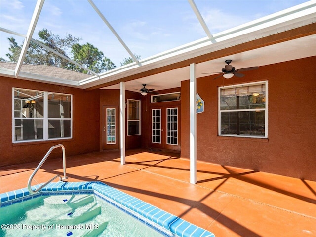 view of swimming pool featuring ceiling fan, a patio, and a lanai