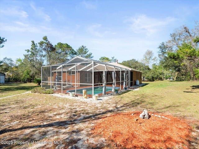 exterior space with an outdoor pool, a yard, and a lanai