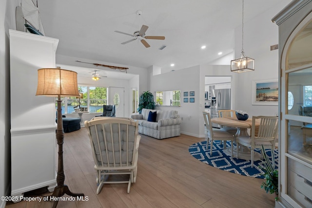 living room featuring visible vents, baseboards, and light wood-style floors