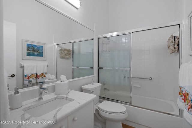 full bathroom featuring vanity, toilet, and enclosed tub / shower combo