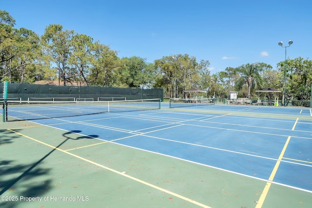 view of tennis court with fence