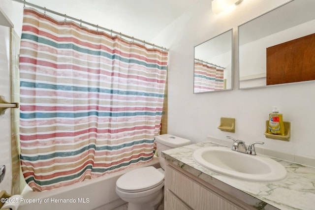 full bath with toilet, vanity, and shower / bath combo