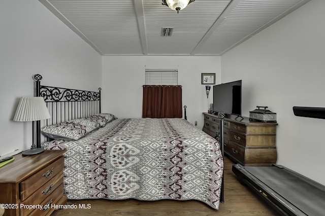 bedroom with visible vents and wood finished floors