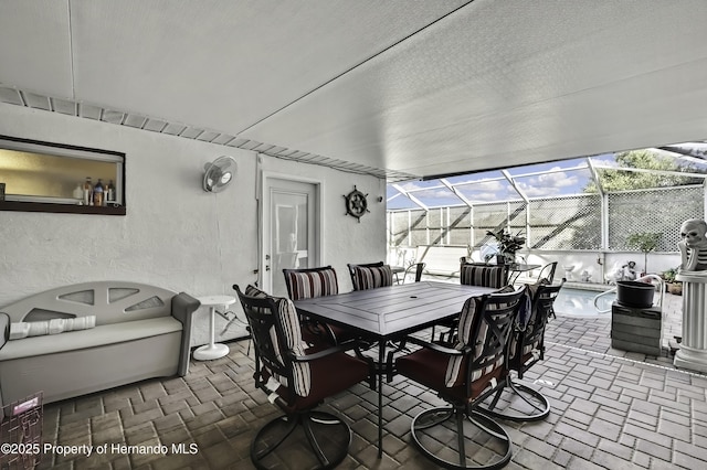 view of patio / terrace with glass enclosure and outdoor dining space