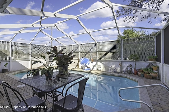 outdoor pool featuring a lanai and a patio