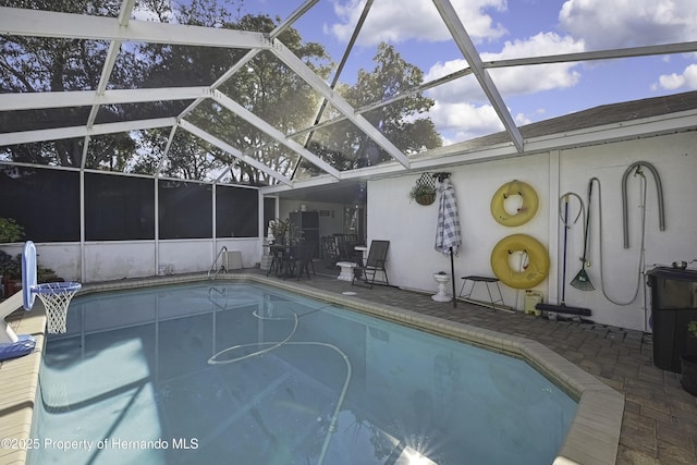 view of pool with a patio and a lanai