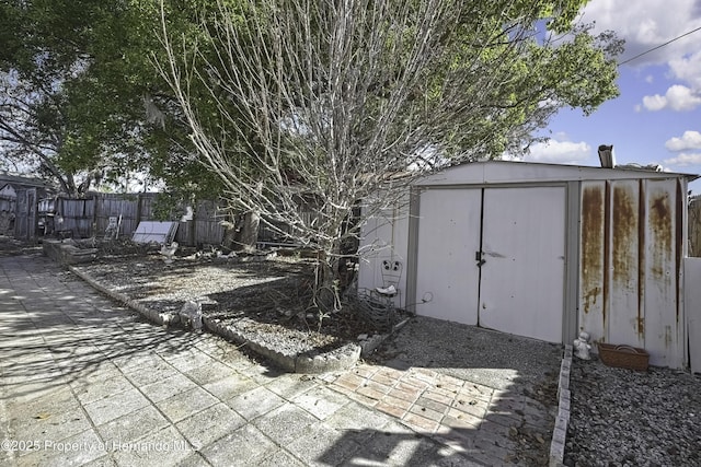 view of shed featuring fence