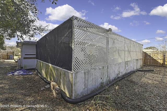 view of side of home with fence