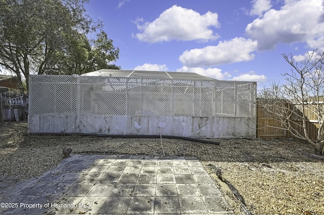 view of gate featuring a fenced backyard and a patio area