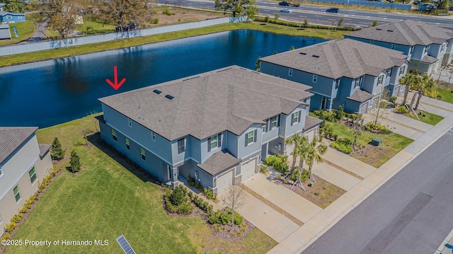 birds eye view of property with a residential view and a water view