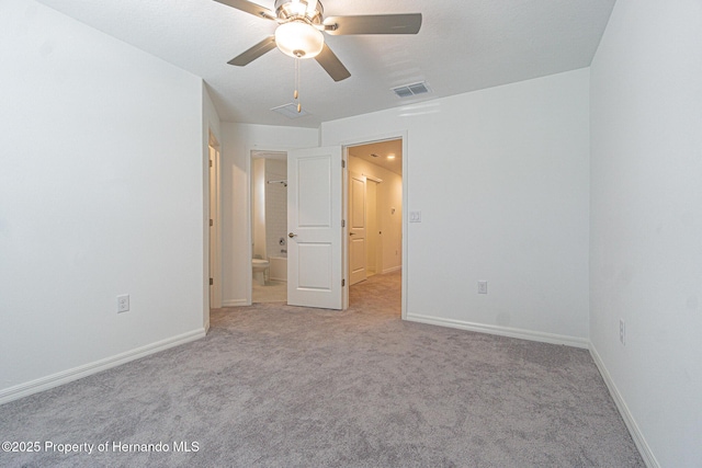 unfurnished bedroom featuring carpet, baseboards, and visible vents